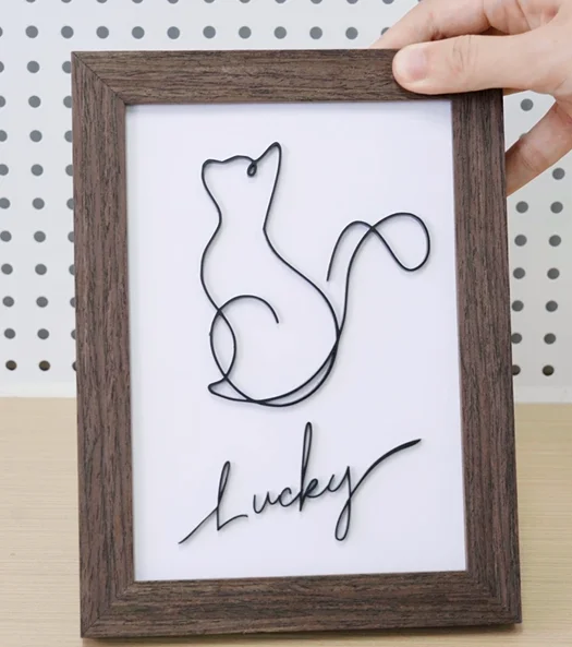 A picture of a laser cut cat decoration.